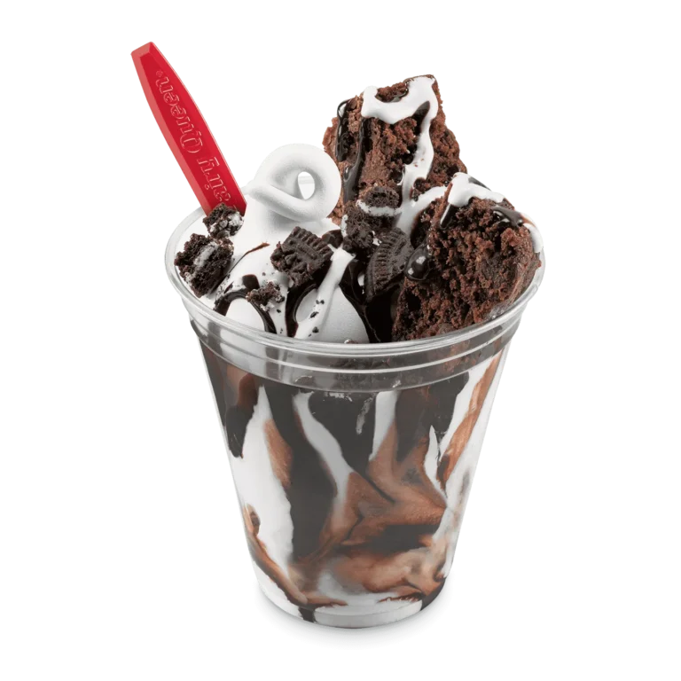 brownie pieces with vanilla soft serve and Oreo cookie pieces in a cup