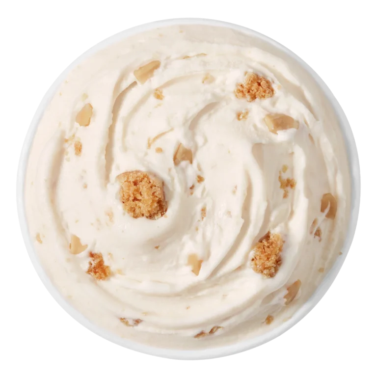 large Blizzard treat with light brown topping and cookie chunks in a clear cup