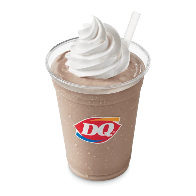 Chocolate shake in a clear cup with whipped topping