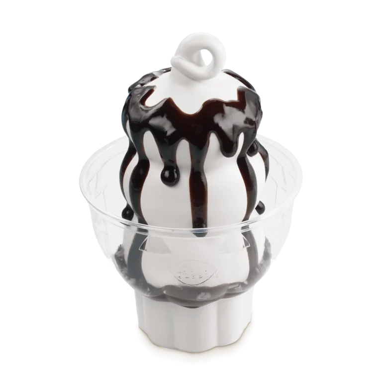 vanilla soft serve sundae topped with hot fudge in a white cup