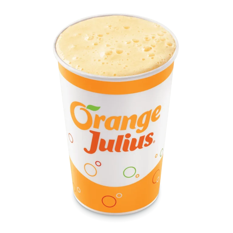 Tall clear cup filled with orange creamy smoothie with a straw