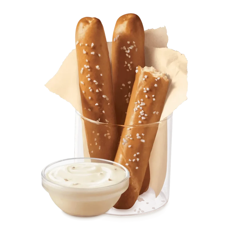 Two servings of pretzel sticks with zesty queso dipping sauce