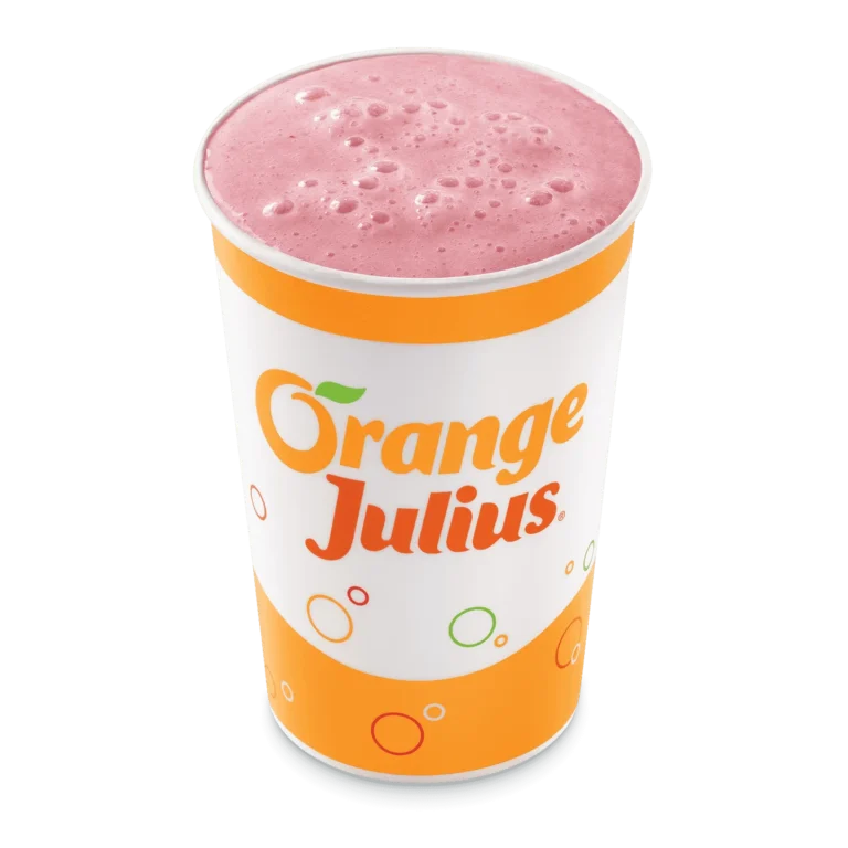 Tall clear cup filled with pink strawberry banana smoothie with a straw