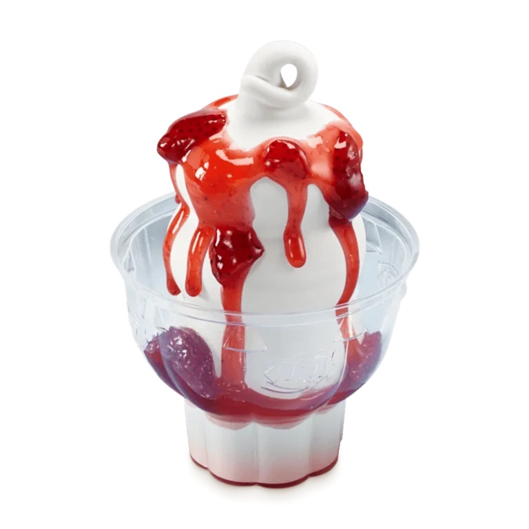 vanilla soft serve sundae topped with strawberry sauce in a white cup