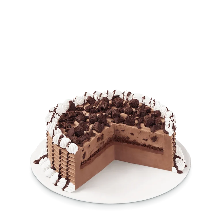 round cake with chocolate brownie pieces and chocolate drizzle topping