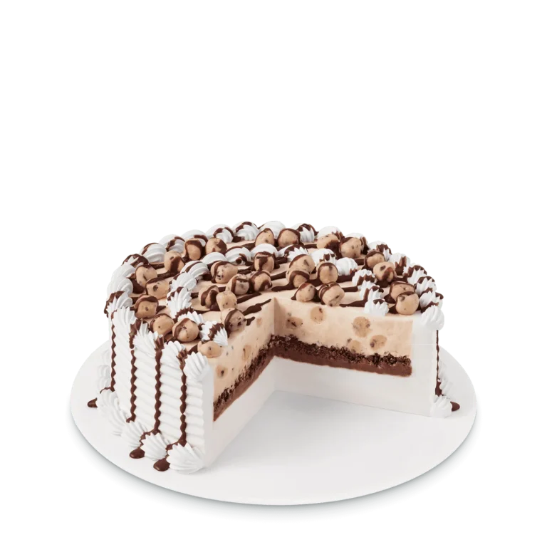 round cake with chocolate chip cookie dough pieces and drizzle on top